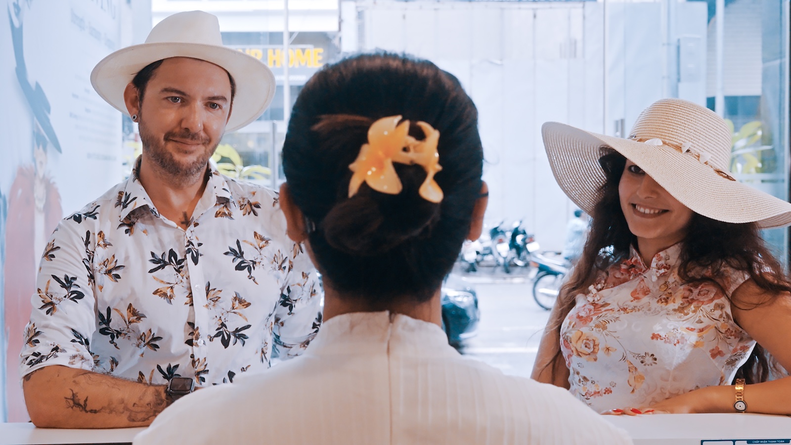 Standing at the clinic reception desk and smiling